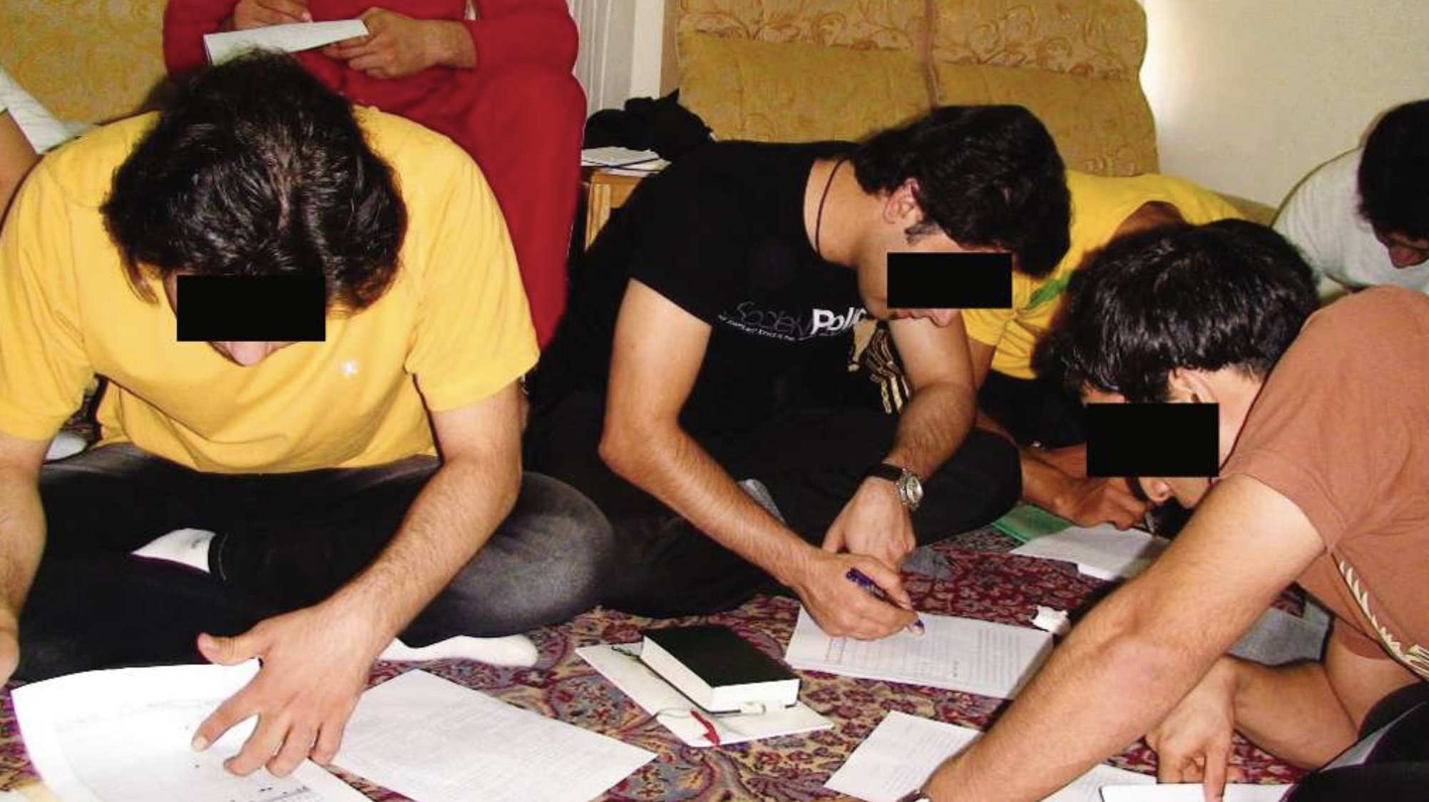 Christians sit on the floor studying Scripture together.