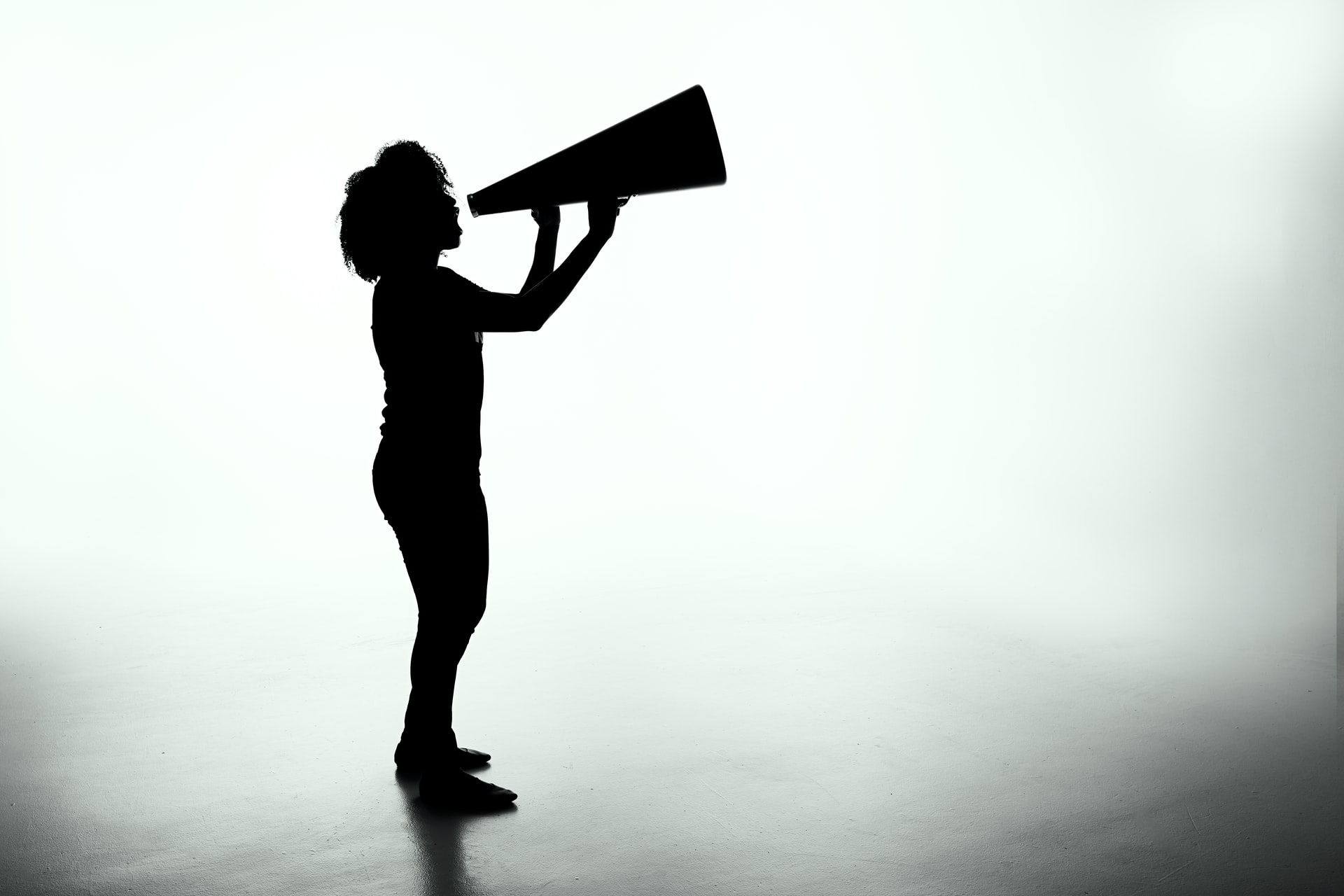 Person shouting into a megaphone