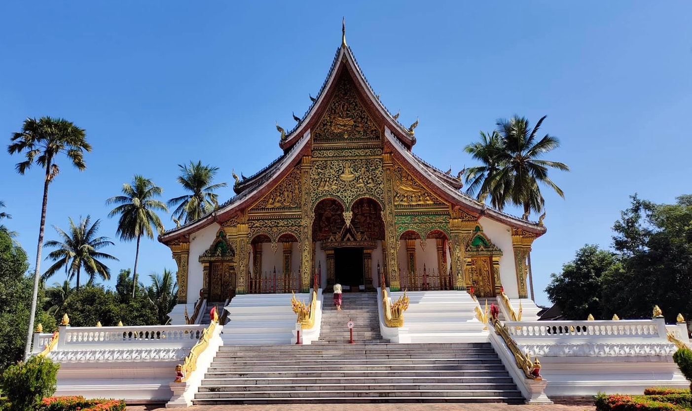 An temple in with palm trees surrounding it