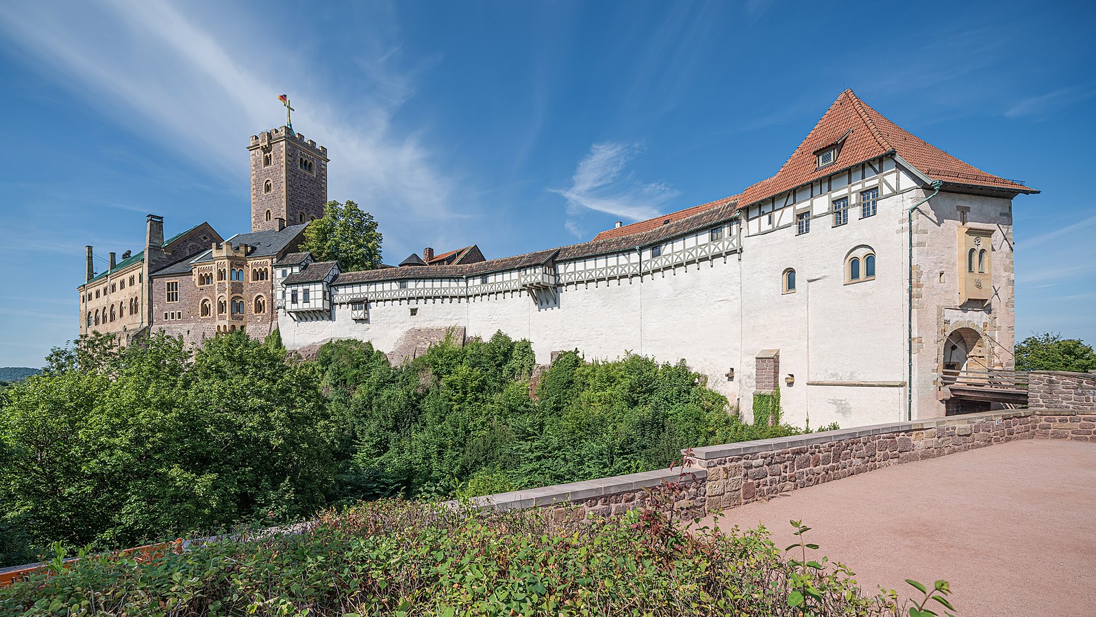 A large castle made from white stone and a brown roof