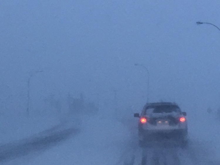 A vehicle driving in a blizzard