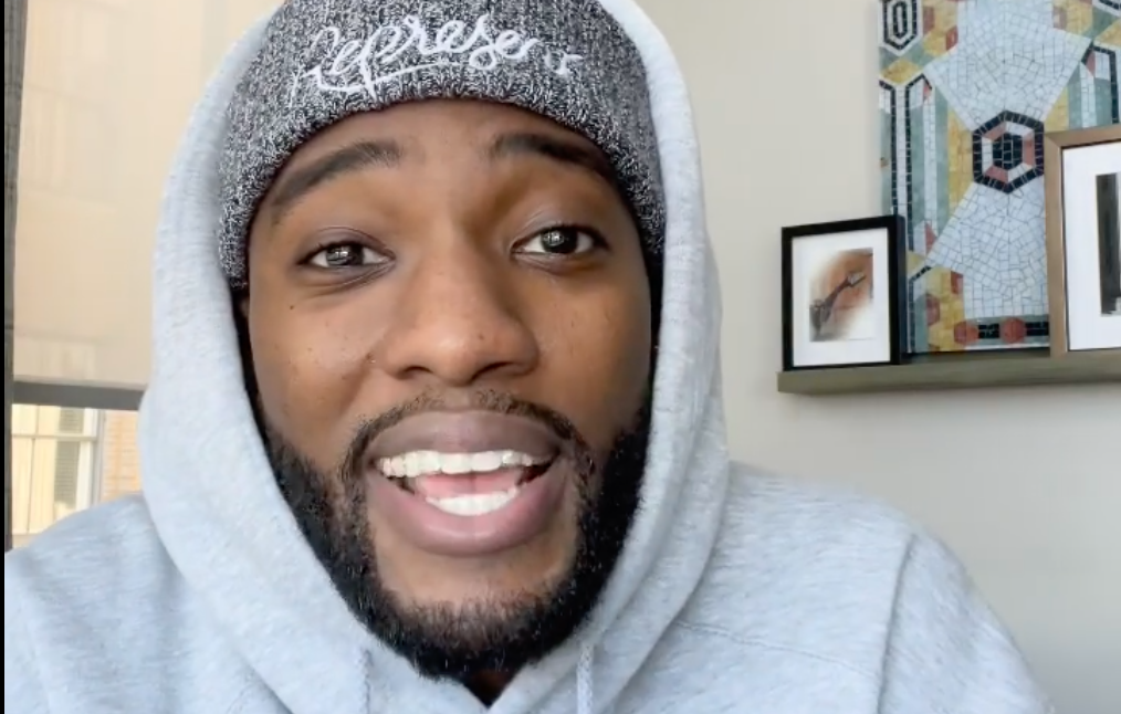 Mike Todd wears a hoodie and toque in a video apology