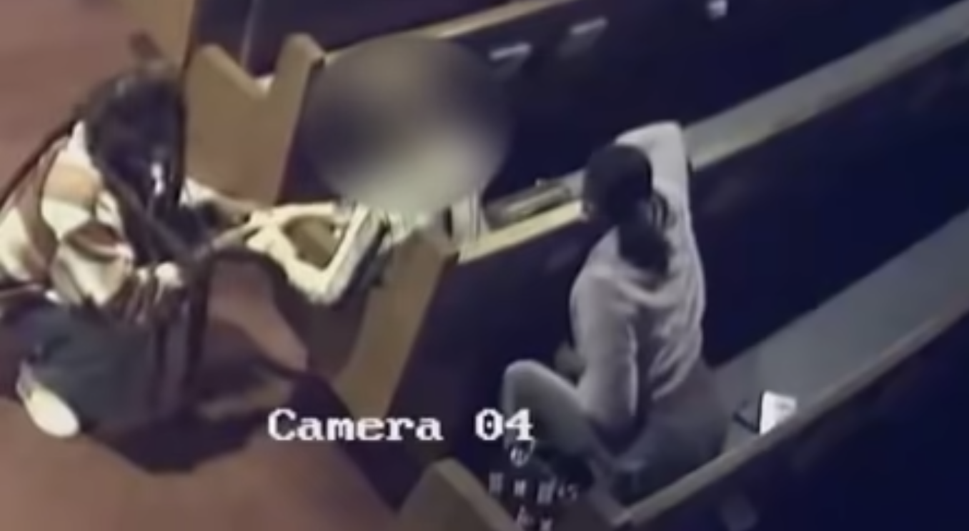 Security camera footage shows 1 suspect kneeling in an aisle and holding a woman's hand who is a sitting in a pew - another suspect in a pew behind her reaches over to get access to the victims purse.