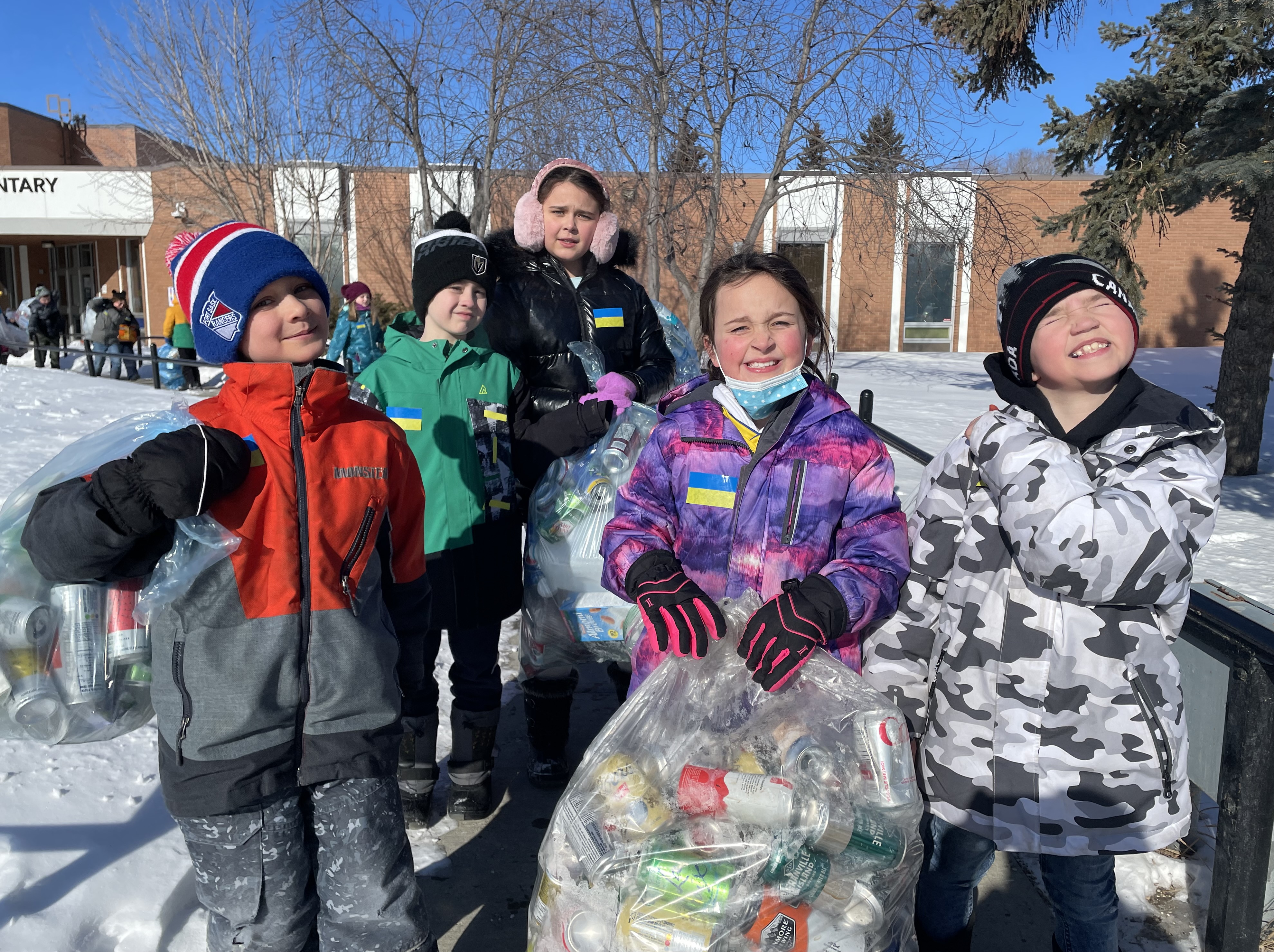 Win Ferguson kids holding bags full of bottles.