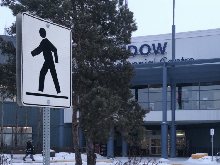 A walking sign in front of the Dow Centennial Centre.