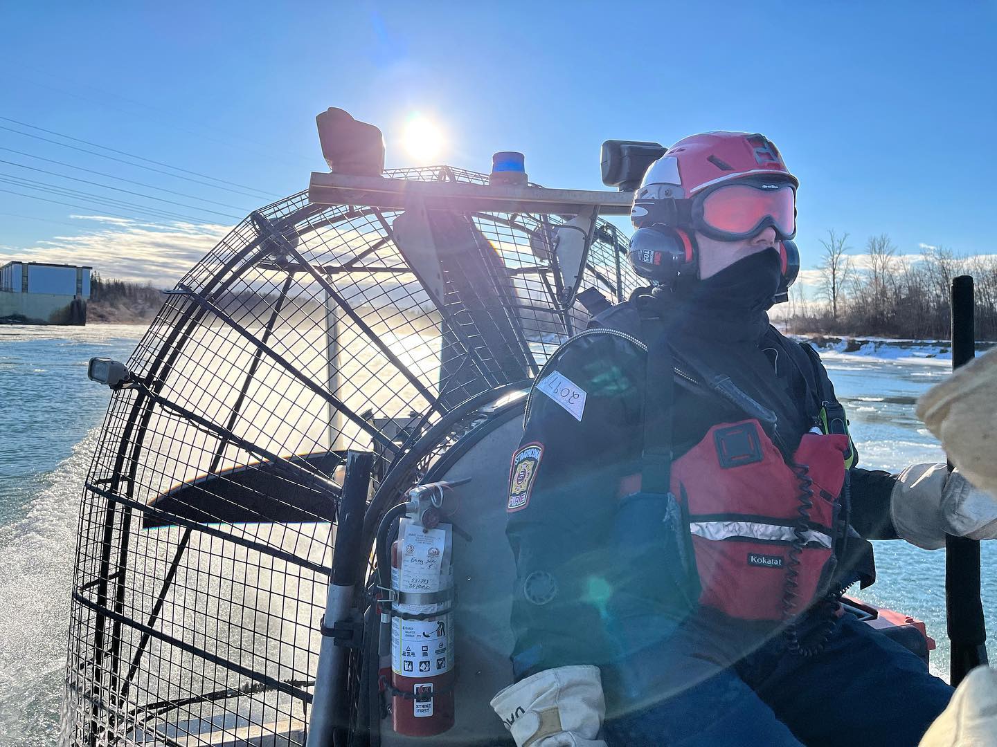 A Strathcona County Emergency Services member on a boat on the river for a training drill.