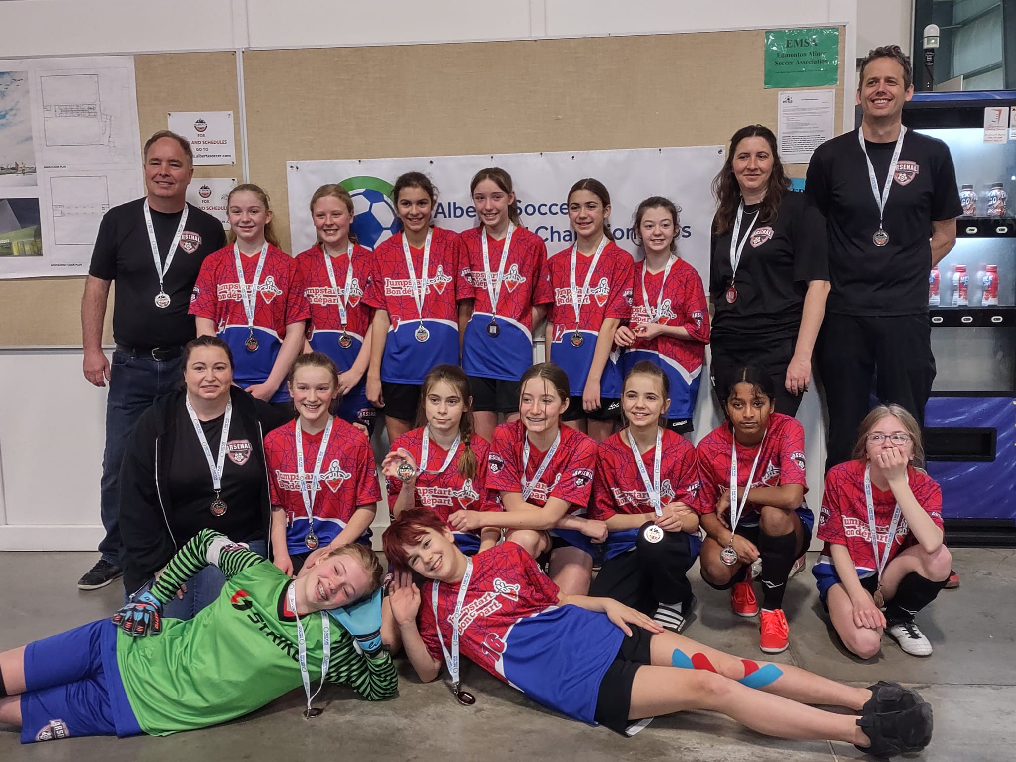 The U13 Girls posing for a photo with their silver medals.