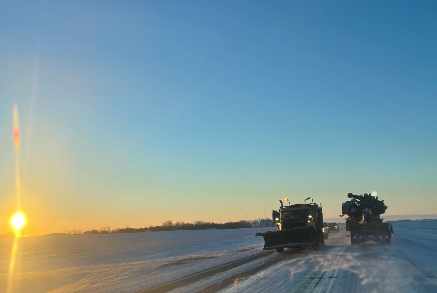 A plow driving on an icy HIghway 39 shortly after sunrise Wednesday morning