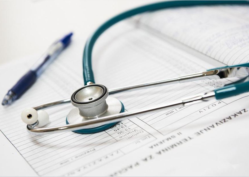 A stethoscope on a doctor's note.