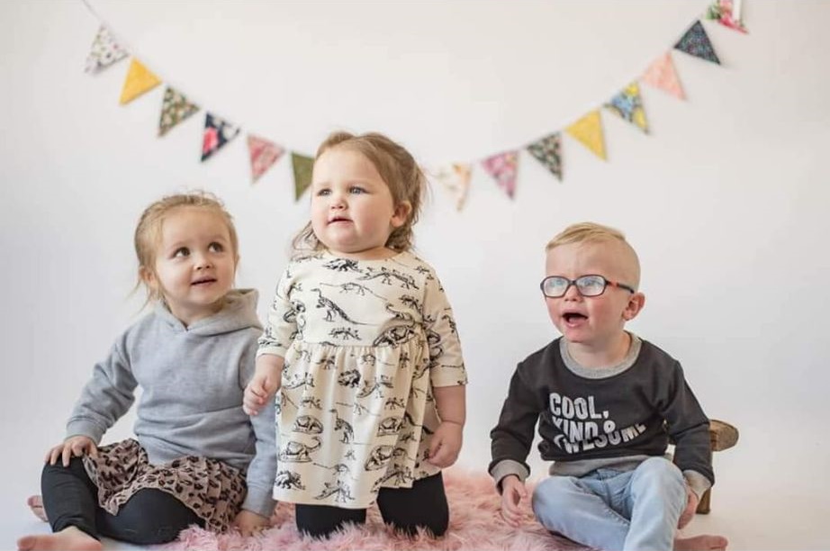 The three Schulz kids sitting together; London, Brittyn and Sawyer.