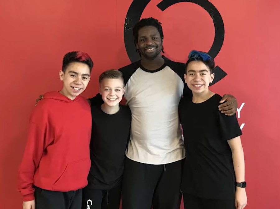 The Itty Bitty Crew and their trainer standing together.