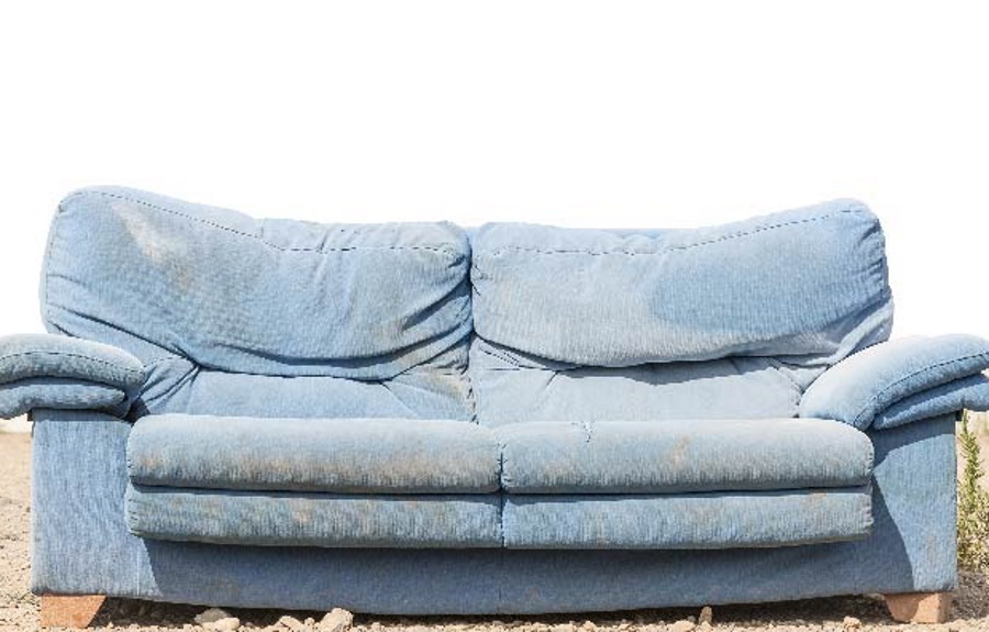 A couch being put outside to be picked up.