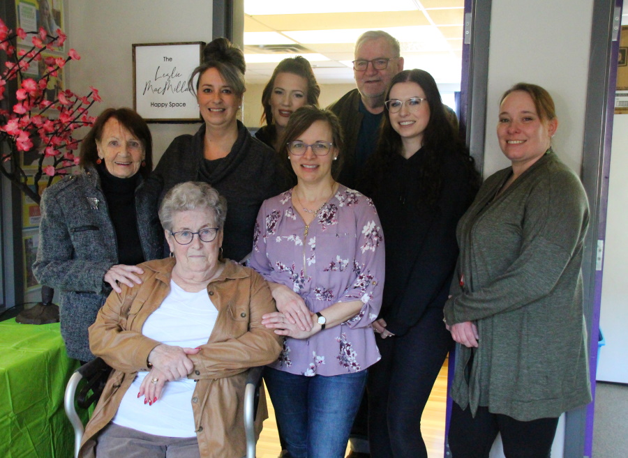 Leslie McMillan, her family and other BGC members standing in front of the 'Leslie McMillan Happy Space.'