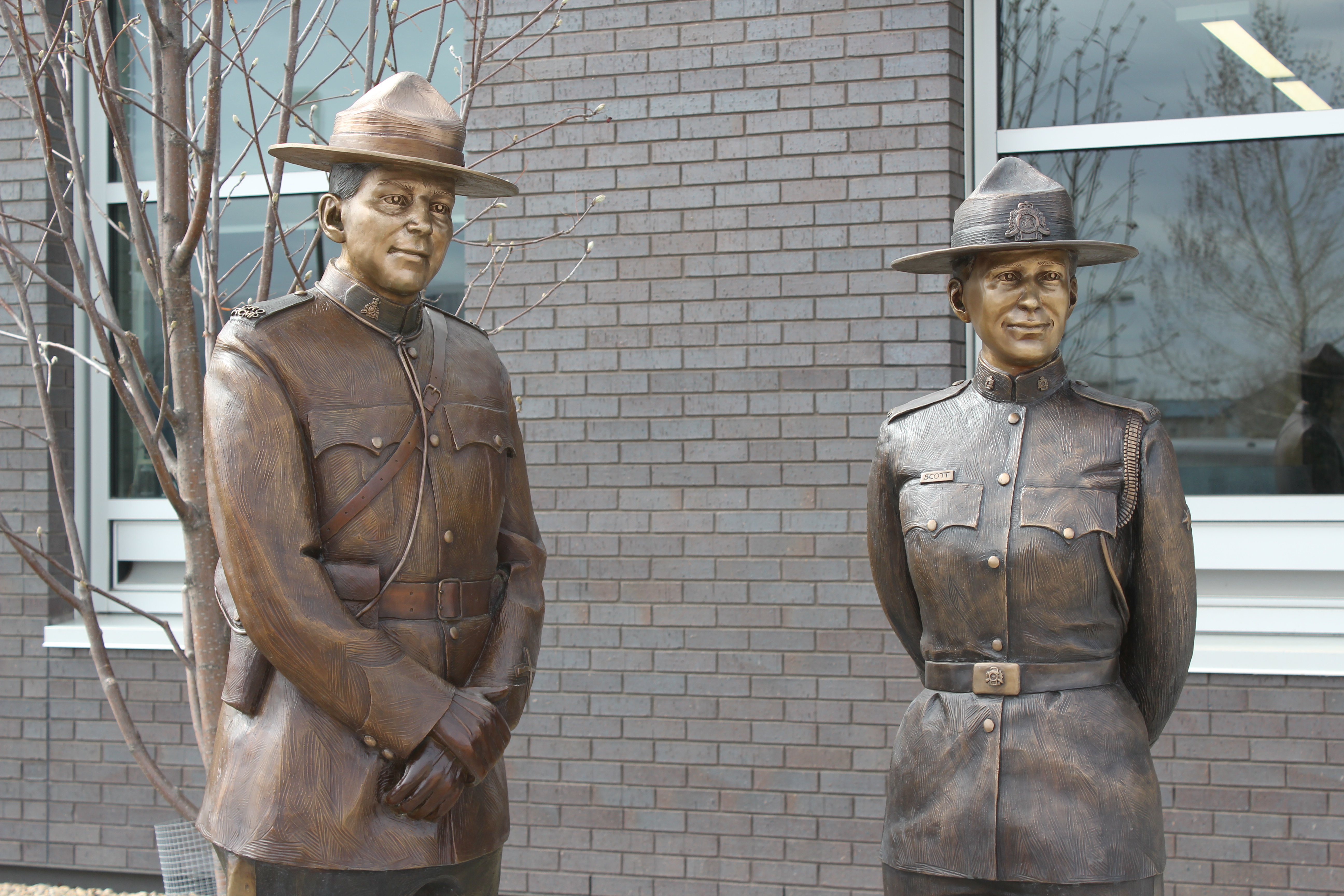 Two statues of RCMP officers.