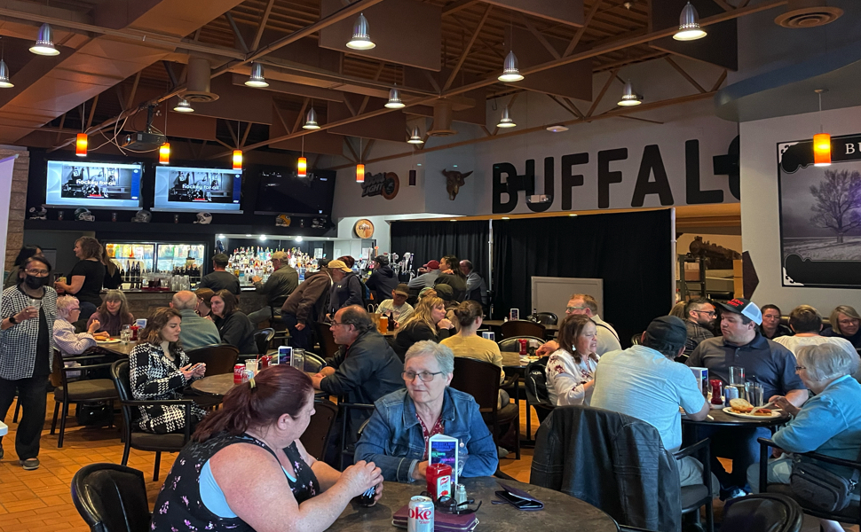 A large crowd gathered around tables
