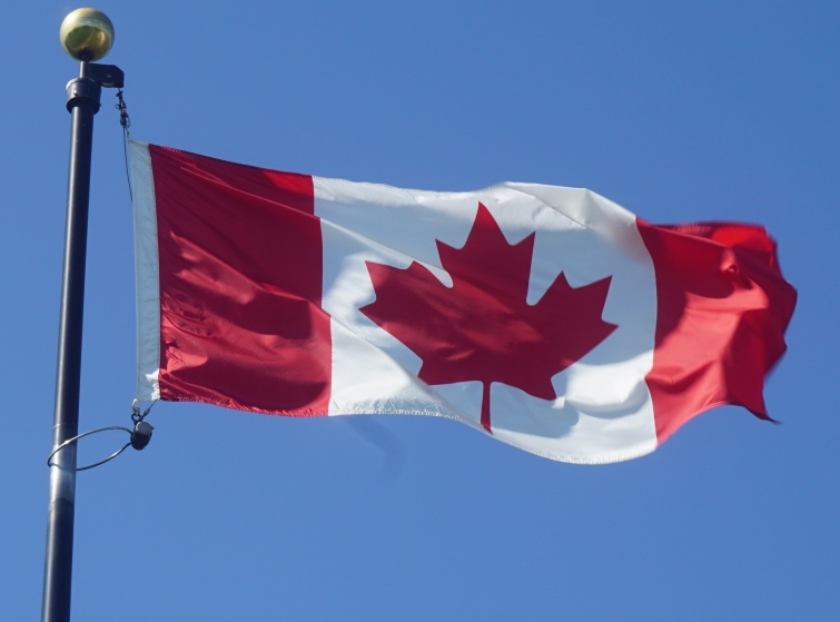 The Canadian flag blowing in the wind.