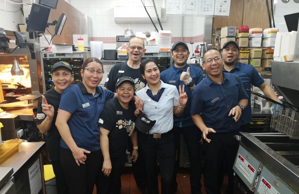 McDonalds employees smile for the camera.