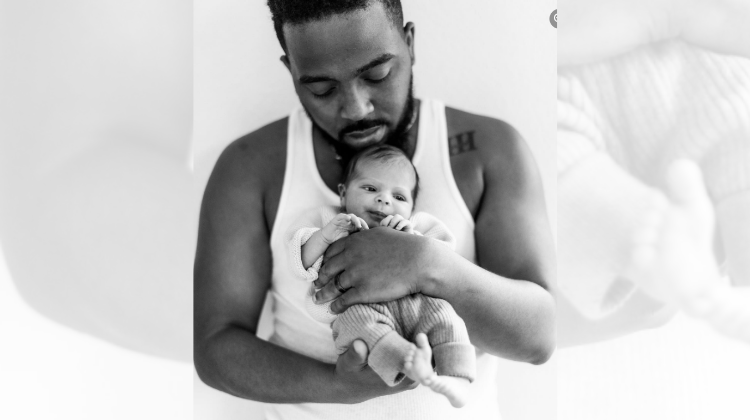 Chandler Moore holding his newborn daughter. 