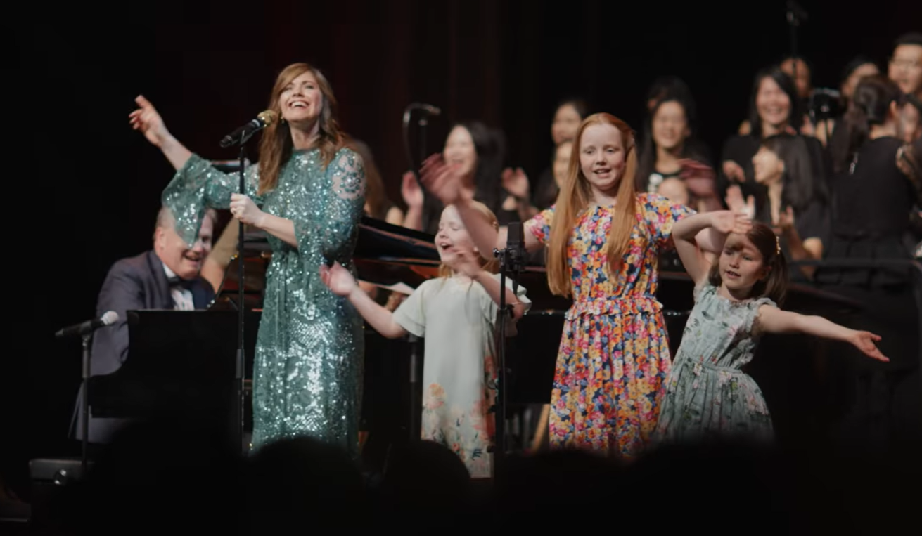 The Getty family singing on stage in Singapore after COVID restrictions lift.