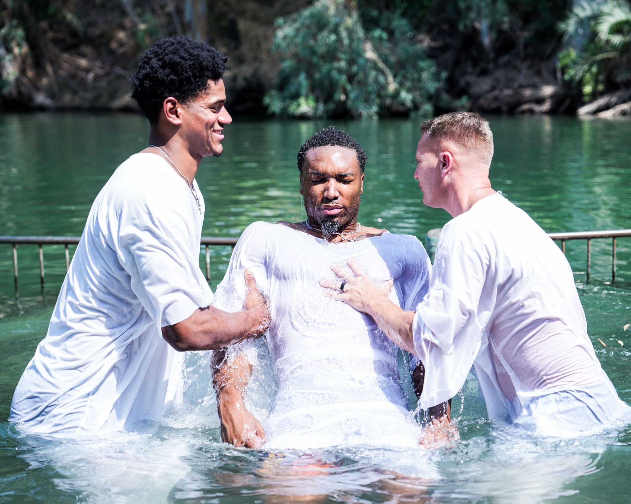 A member of Auburn Basketball team getting baptized in the Jordan River. 