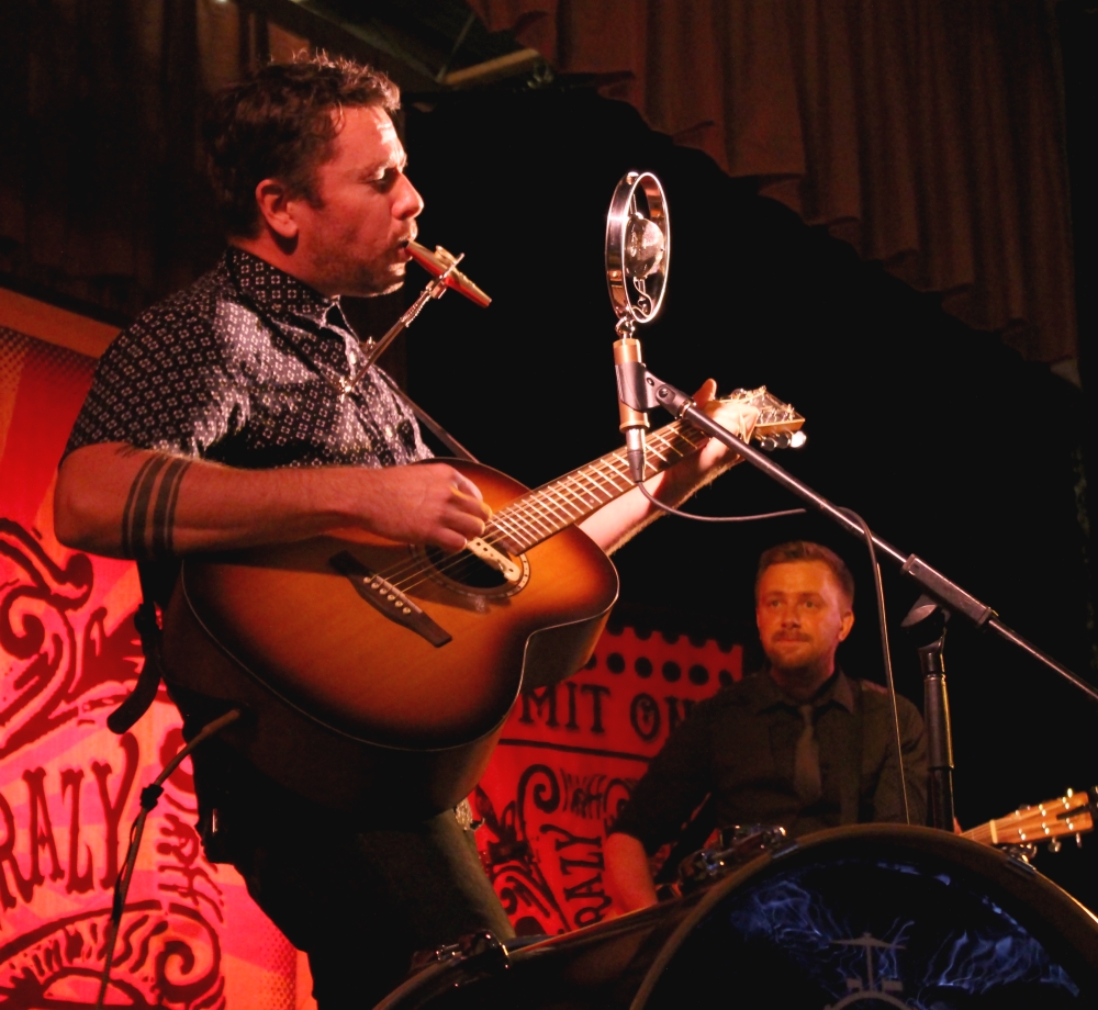 a man playing guitar and singing