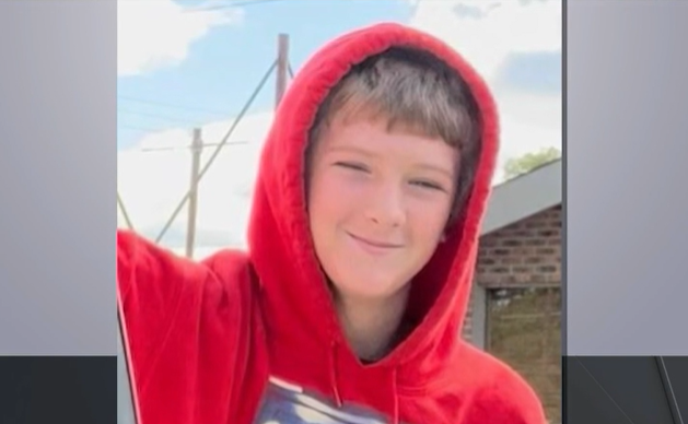 a young boy with light skin tone wears a red hoodie