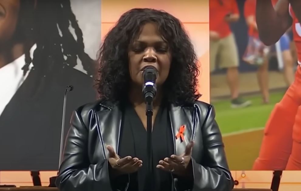 Cece Winans performing at the funeral of three football players shot at the University of Virginia. 