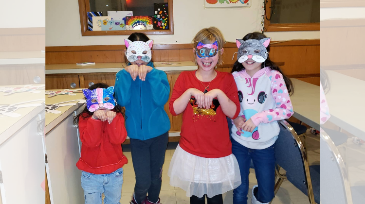 a group of young girls wearing DIY cat masks (Kreative Kids/FB)