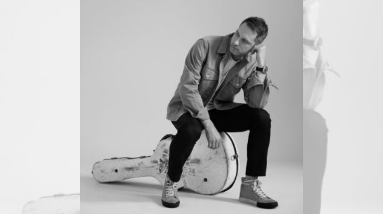 white male sitting on guitar case (Brandon Heath/provided by Centricity Music)
