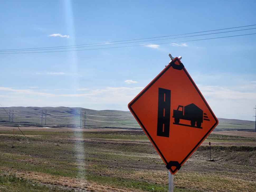 Road work sign over a valley