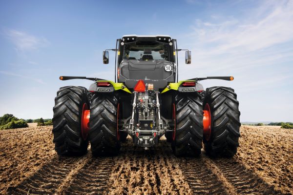 shot of CLAAS tractor from behind working in a field