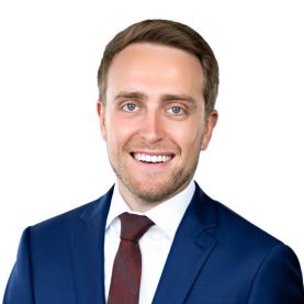 Photo of Kyle Larkin in Blue suit with white shirt and burgandy tie