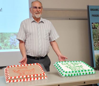 Bruce McArthur with two retirement cakes 