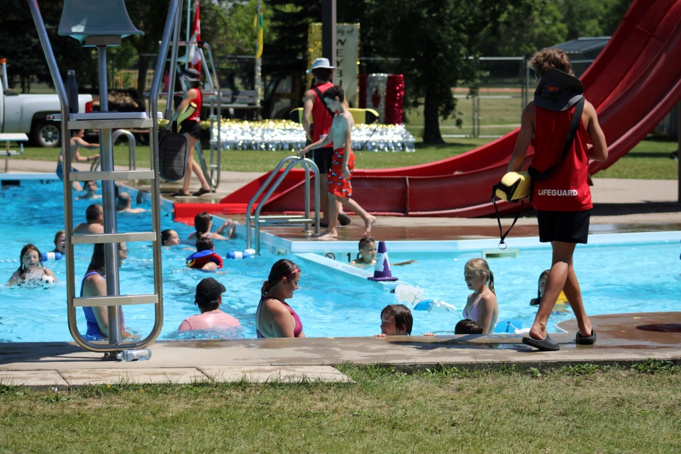 People enjoying the outdoor pool in Weyburn