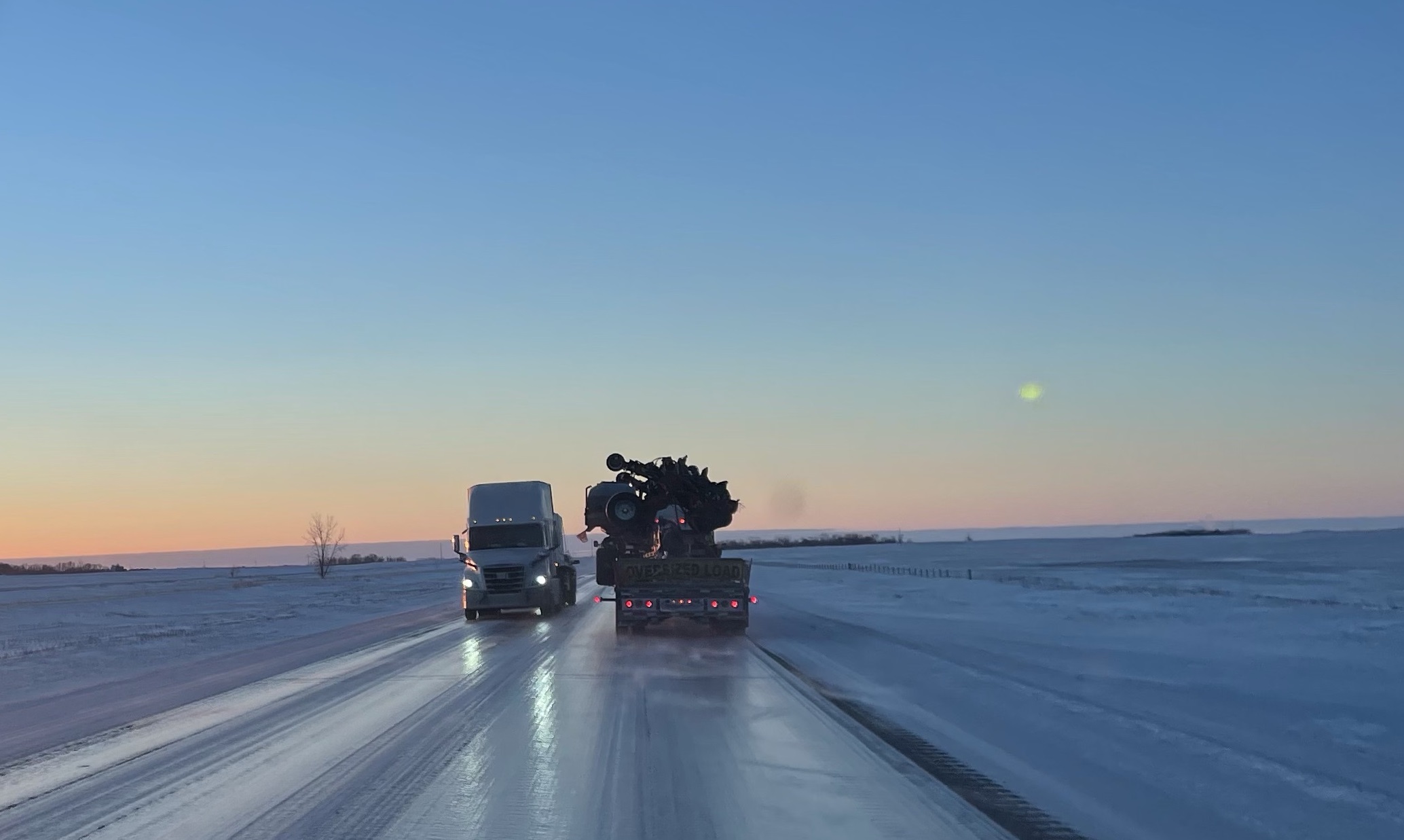 Trucks crossing paths on an icy highway in the southeast