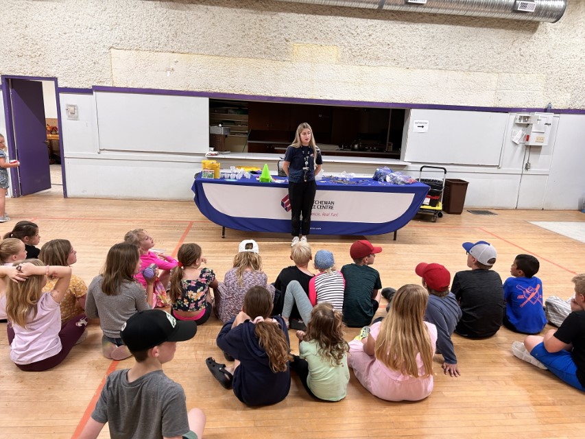 children sitting around the Go! Science Outreach Program presentation.