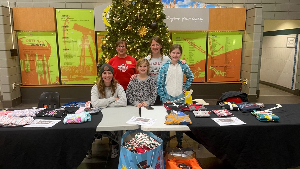 Estevan Kinettes collecting pyjamas at Bruins game - 112325