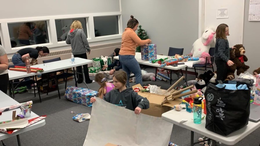 Volunteers wrapping presents for Santa Cause 