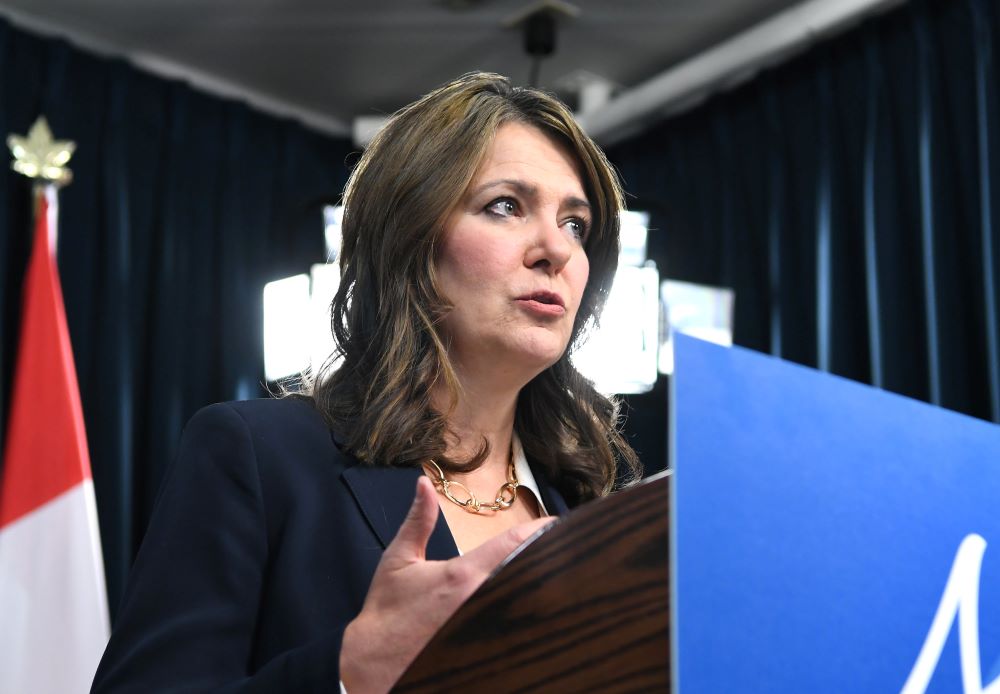 Alberta Premier Danielle Smith stands at a podium at the November 26 announcement.