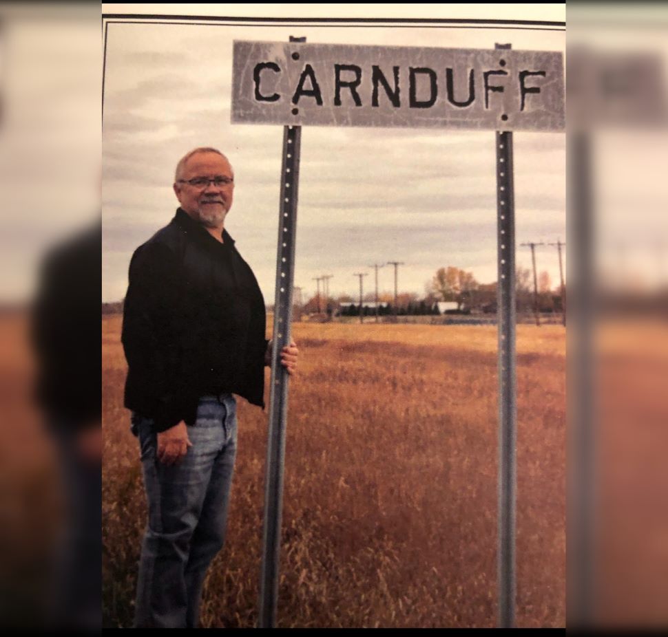 Carnduff Mayor Ross Apperley with Carnduff sign 