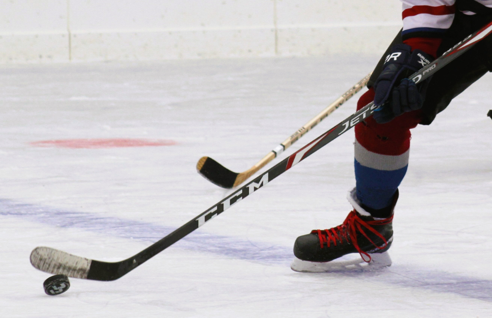 A hockey player handling a puck.