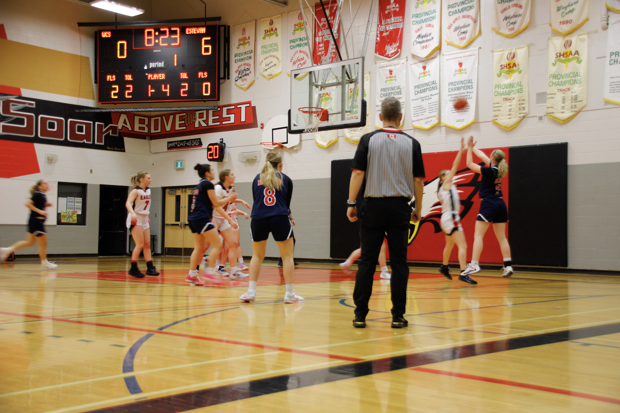 A basketball game between teams in dark blue and red