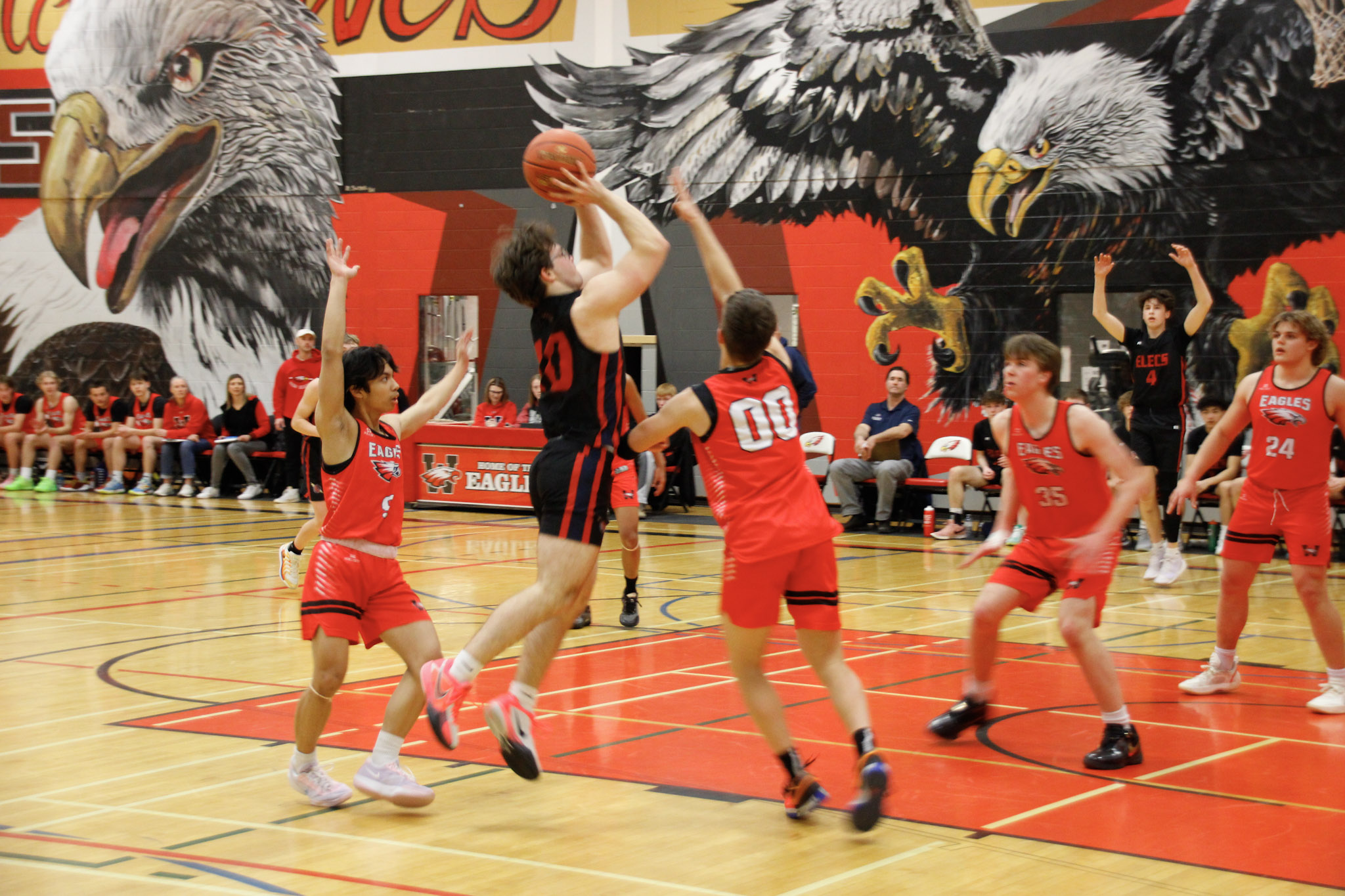 A basketball game between teams in dark blue and red