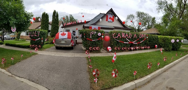 Bienfait house with many Canadian flags