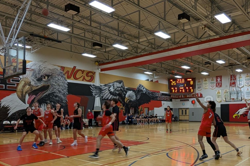 A three point shot attempt in a basketball game. 