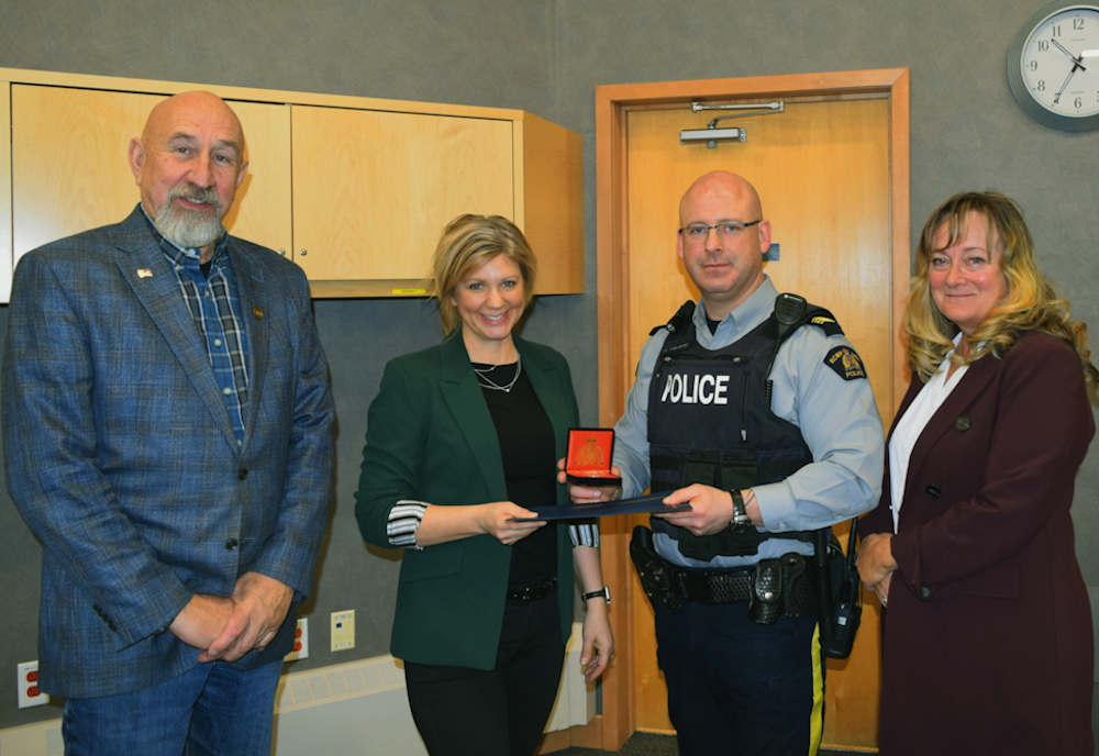 Strathmore RCMP presented Wheatland County with a commemorative coin celebrating 100 years of serving the area.