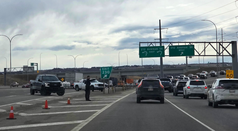 Traffic being redirected on Deerfoot after a collision.
