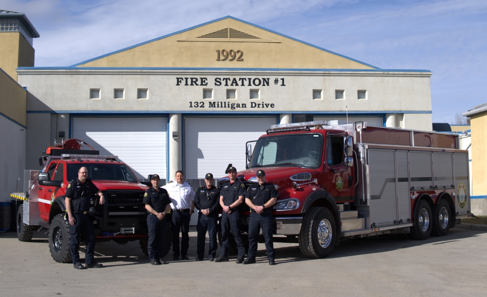 Members of Okotoks Fire & Rescue posing with the two new vehicles.