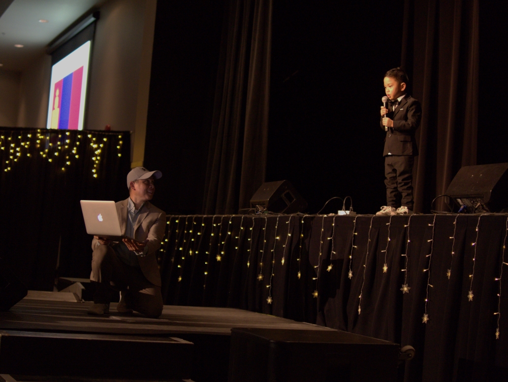 Praise Dela Cruz performing his flag naming act at Okotoks Got Talent.