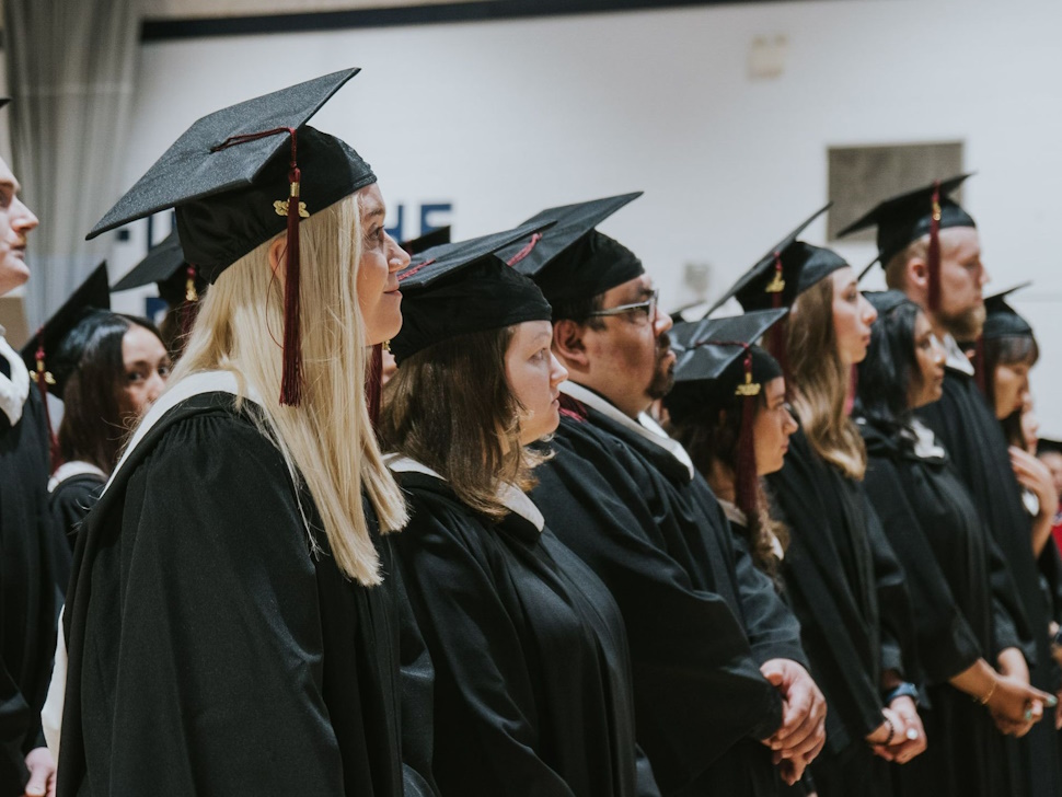 Providence graduates stand in a crowd 